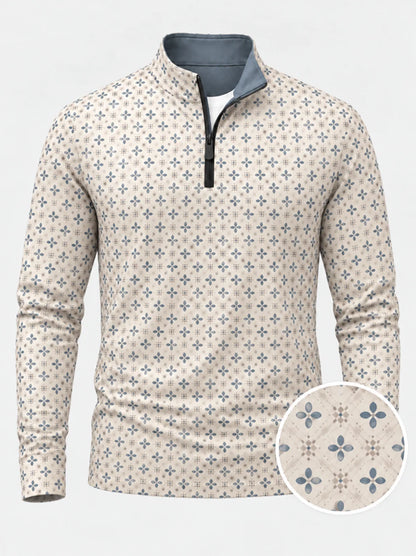 Cremefarbener Golfpullover aus Funktionsmaterial mit blauem Blumenmuster und kurzem Reißverschluss