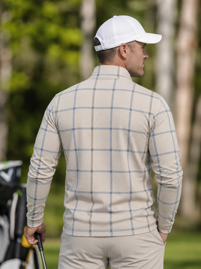 Cremefarbener Golfpullover aus Funktionsmaterial mit blauem Karomuster und kurzem Reißverschluss