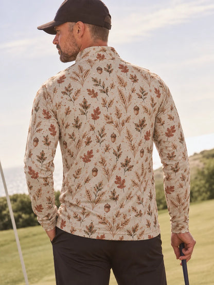 Cremefarbener Golfpullover aus Funktionsmaterial mit herbstlichem Blumenmuster und kurzem Reißverschluss